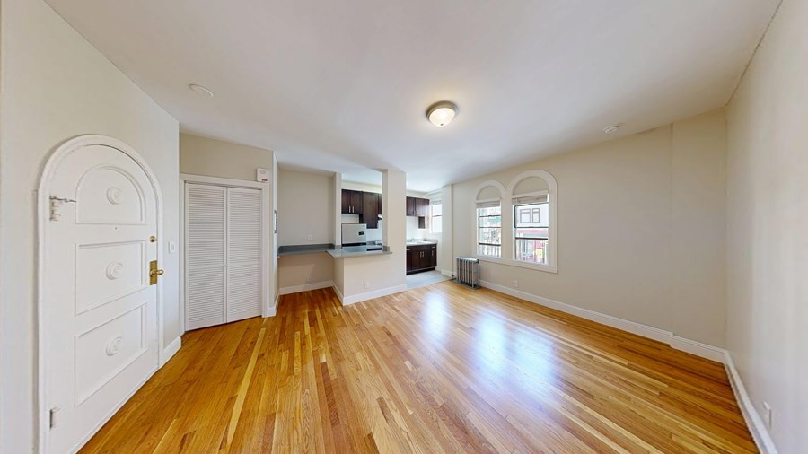 A room with wooden floors and white walls.